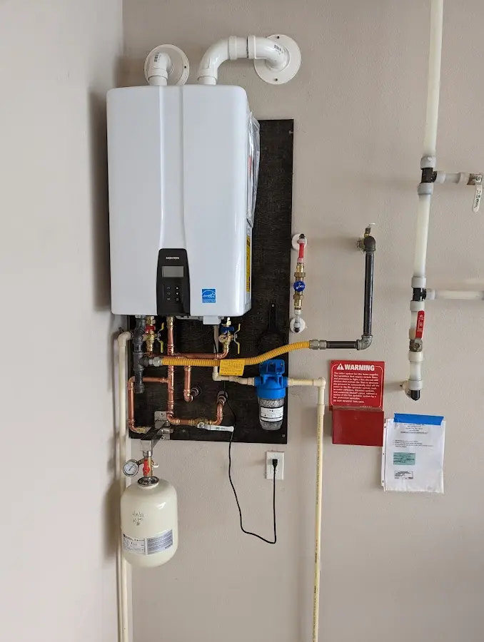 Professional plumber installing copper piping in a Foothill Farms home